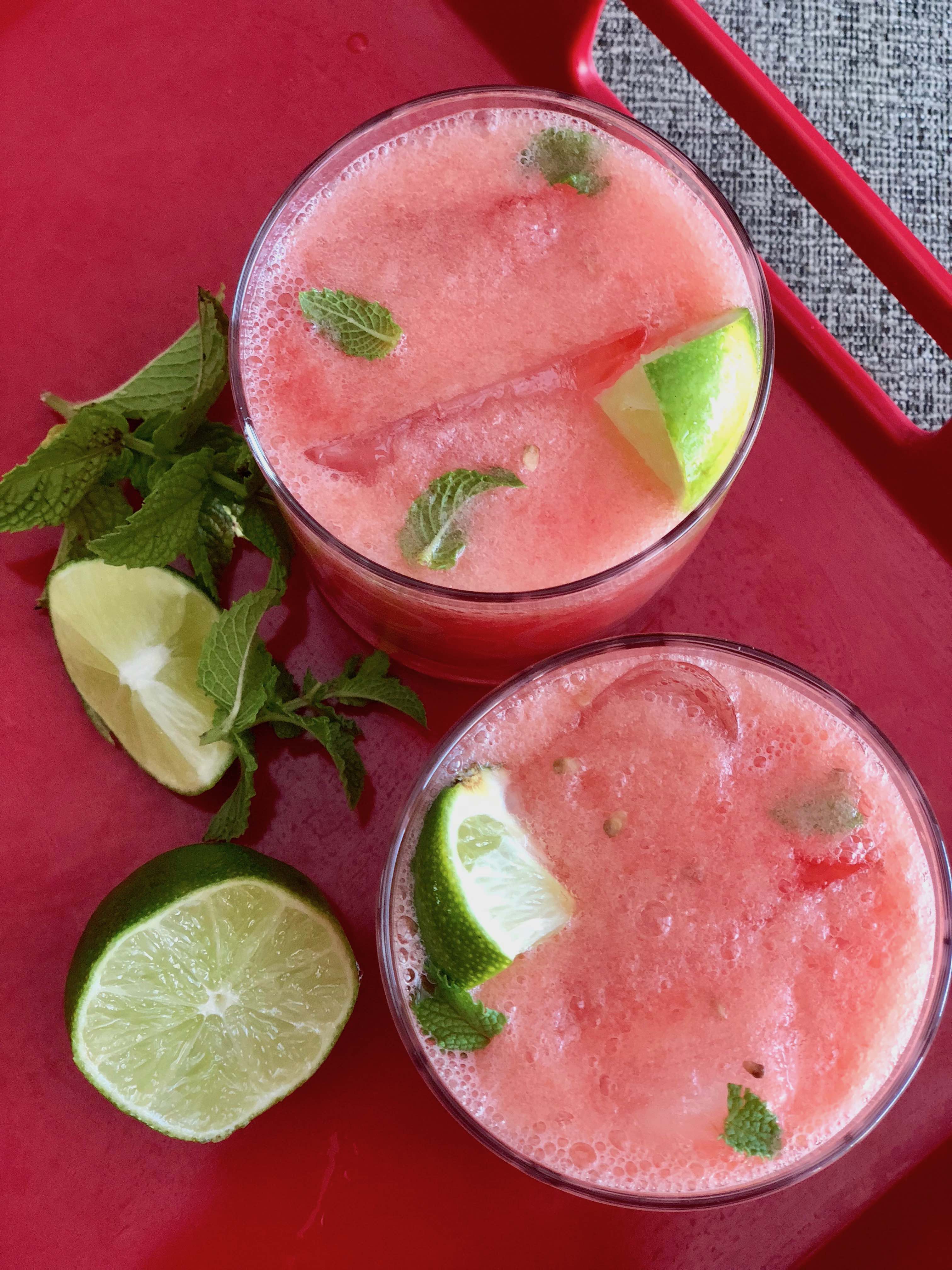This watermelon mojito cocktail recipe takes full advantage of summer's bountiful produce. Fresh watermelon and mint and a squeeze of lime are the perfect combination for this light and refreshing drink. Use rum for a traditional mojito, or substitute tequila. For a Whole30 mocktail, omit the alcohol - it's still delicious! | www.amiofbs