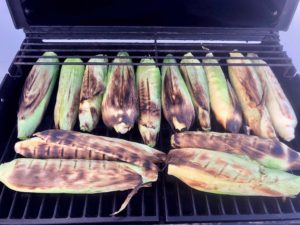 Here's a super easy "recipe" for cooking corn-on-the-cob on the grill. This is my preferred method because the corn cooks right in the husks, eliminating most of the mess that comes from shucking.&nbsp; You shuck the corn AFTER it is cooked, and it's less messy because the silk slides right off with the corn husk. | www.amiofbs.com