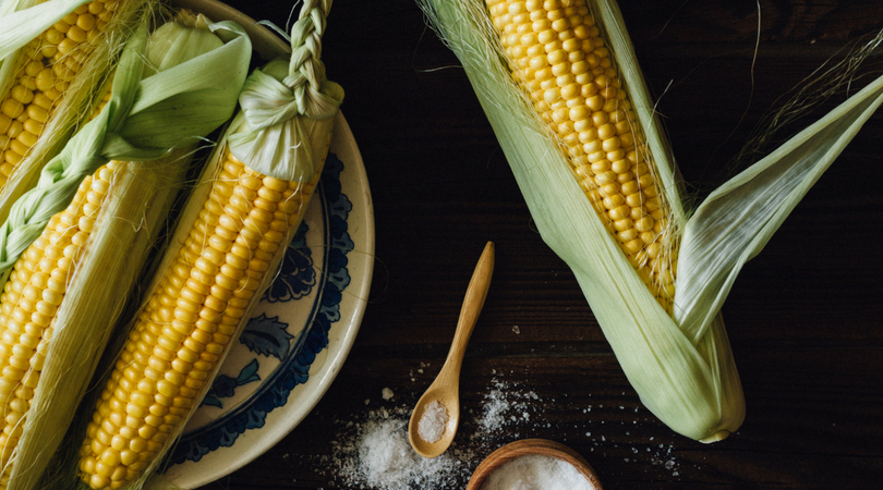 Here's a super easy "recipe" for cooking corn-on-the-cob on the grill. This is my preferred method because the corn cooks right in the husks, eliminating most of the mess that comes from shucking.  You shuck the corn AFTER it is cooked, and it's less messy because the silk slides right off with the corn husk. | www.amiofbs.com
