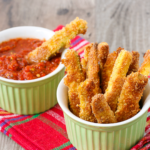 These easy baked zucchini fries feature Parmesan-crusted zucchini baked until hot and crispy and dunked in a smoky, spicy ketchup. You've gotta try these! | www.amiofbs.com