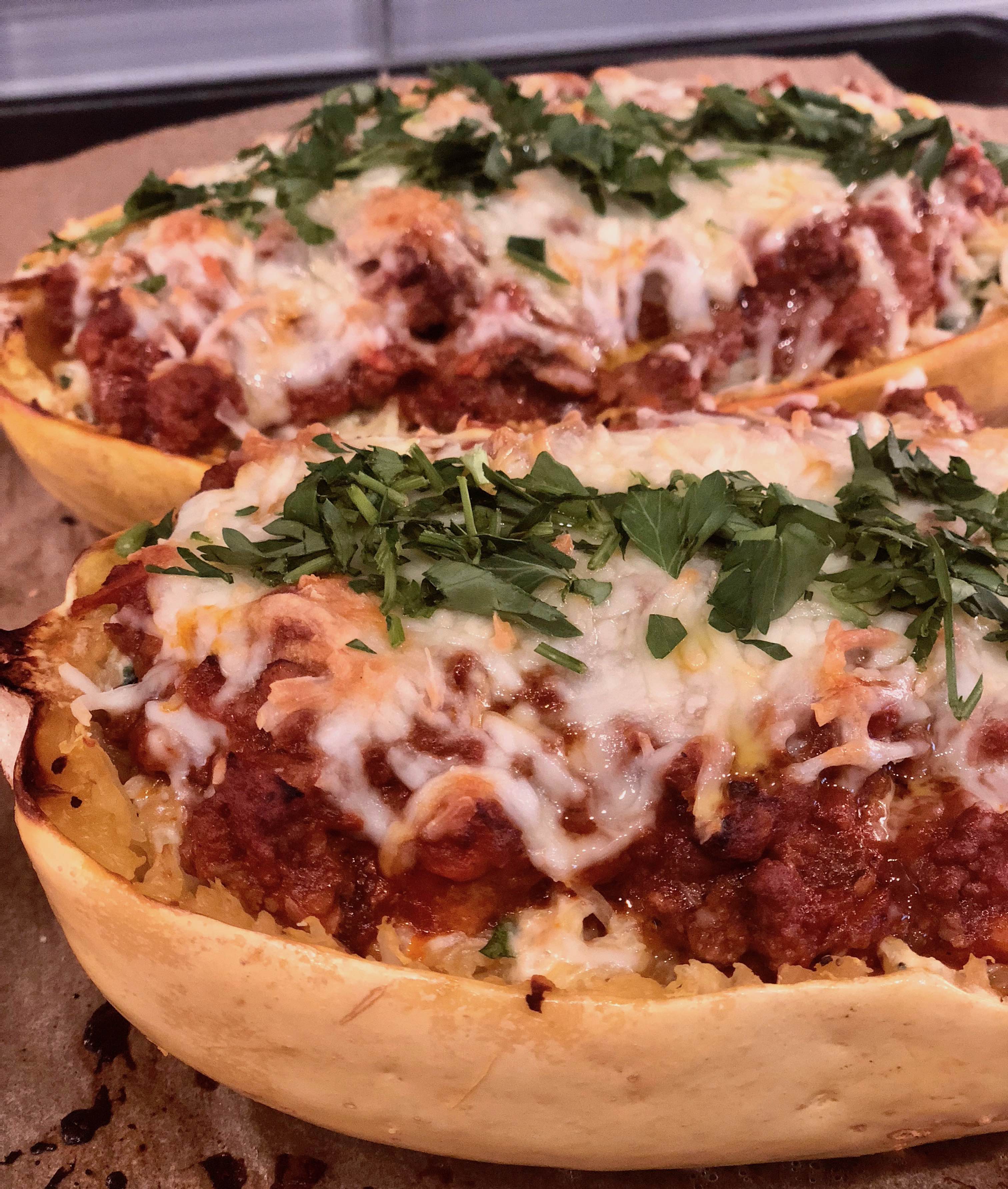 This gluten-free spaghetti squash lasagna recipe will be your new BFF. Tasty spaghetti squash tossed with garlicy greens, two kinds of cheese & savory meat sauce. So ridiculously good! | www.amiofbs.com