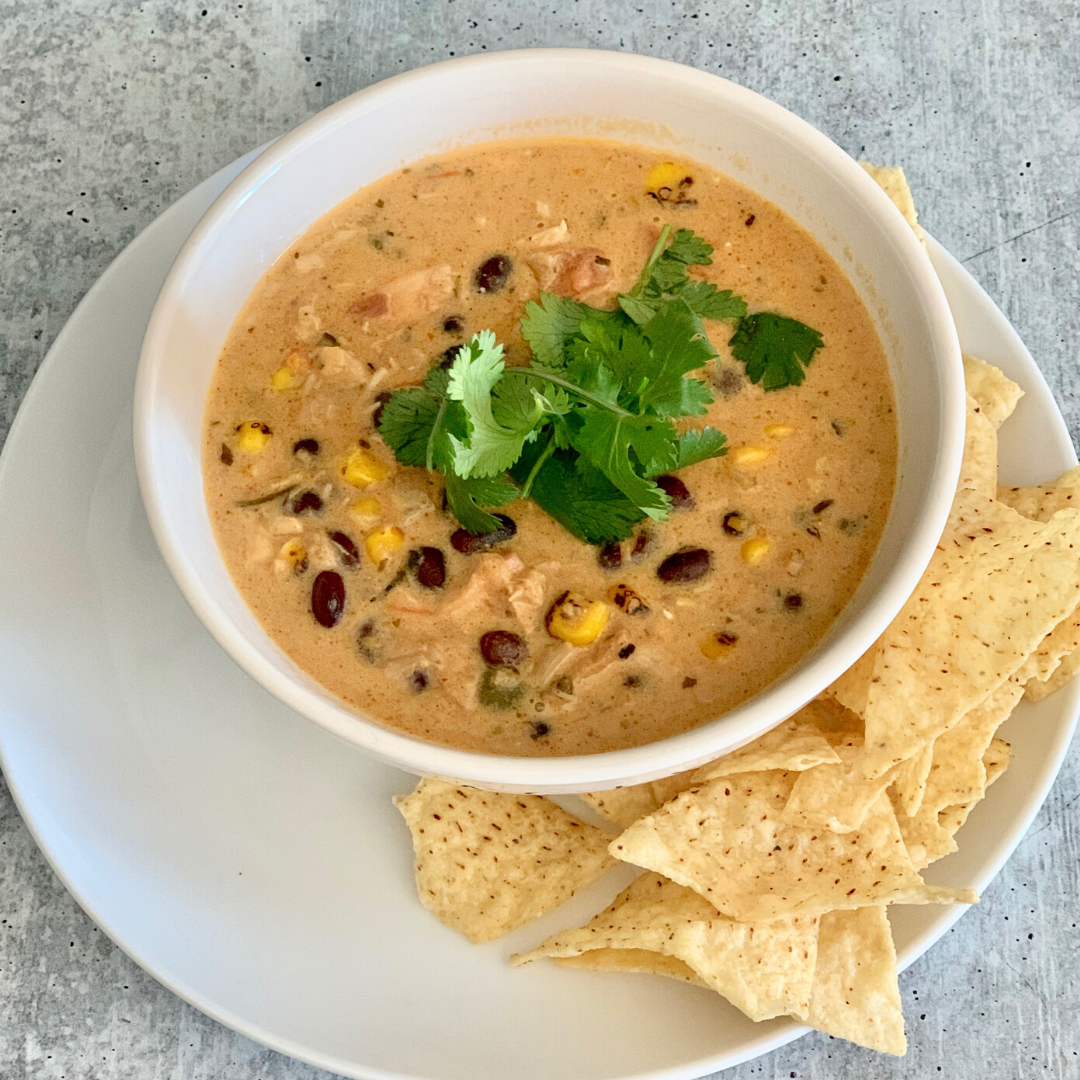 Easy chicken queso soup is cheesy, a little bit spicy, very creamy, very hearty, and oh so delicous. Quick & easy to make with leftover rotisserie chicken. | www.amiofbs.com
