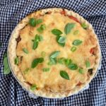 Make a quick and easy southern tomato pie. Tuck ripe tomatoes into a buttery pie crust and top with a layer of melty cheese. It's delicious! | www.amiofbs.com
