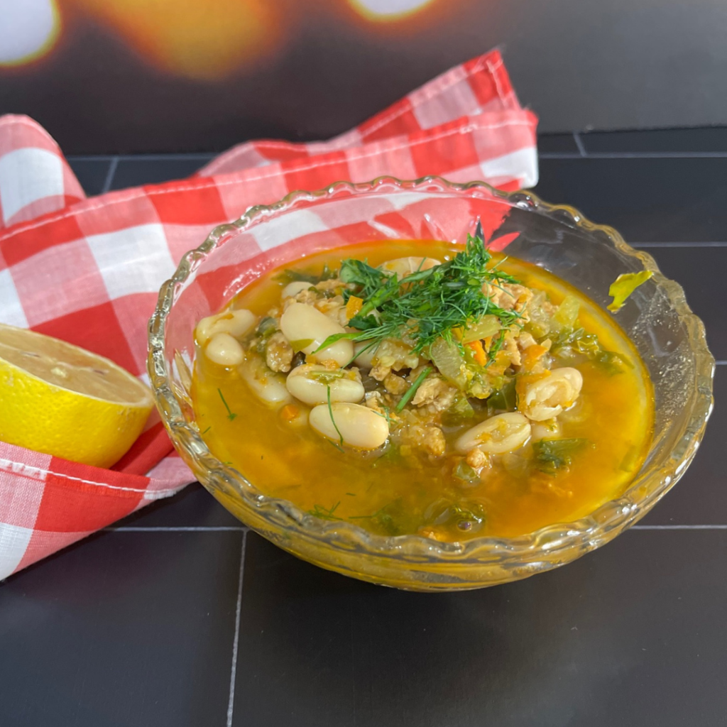 This Lemon Chicken Vegetable Soup is packed with greens and beans and is oh so delicious. You can make it one pot and it freezes beautifully! | www.amiofbs.com
