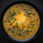 Cheeseburger soup is the hearty, rich, creamy soup of your dreams. Perfect for a cold winter night, especially when you serve it alongside some crusty sourdough bread. Don't forget the toppings! | www.amiofbs.com