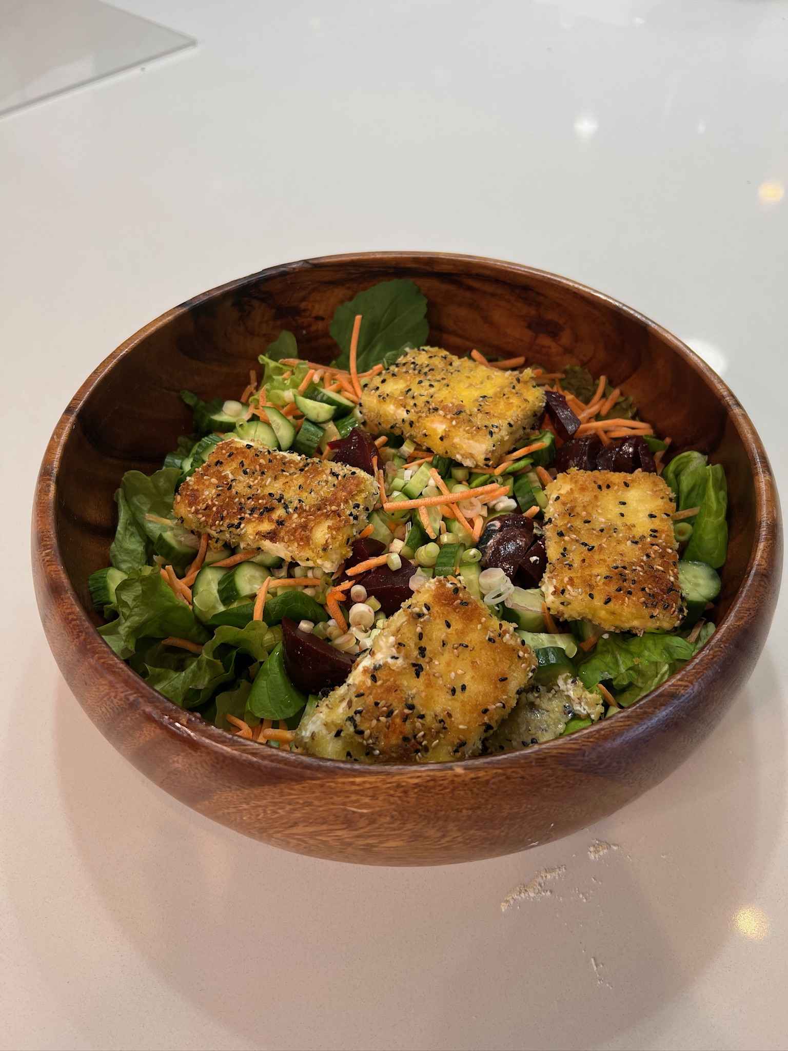 Fried Feta salad in wooden bowl